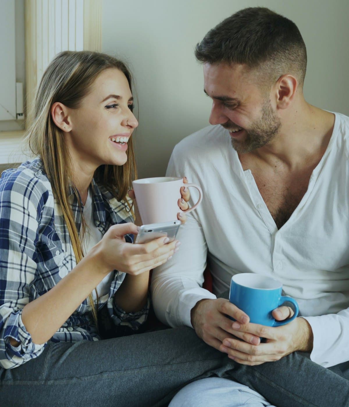 A couple talking and laughing over coffee