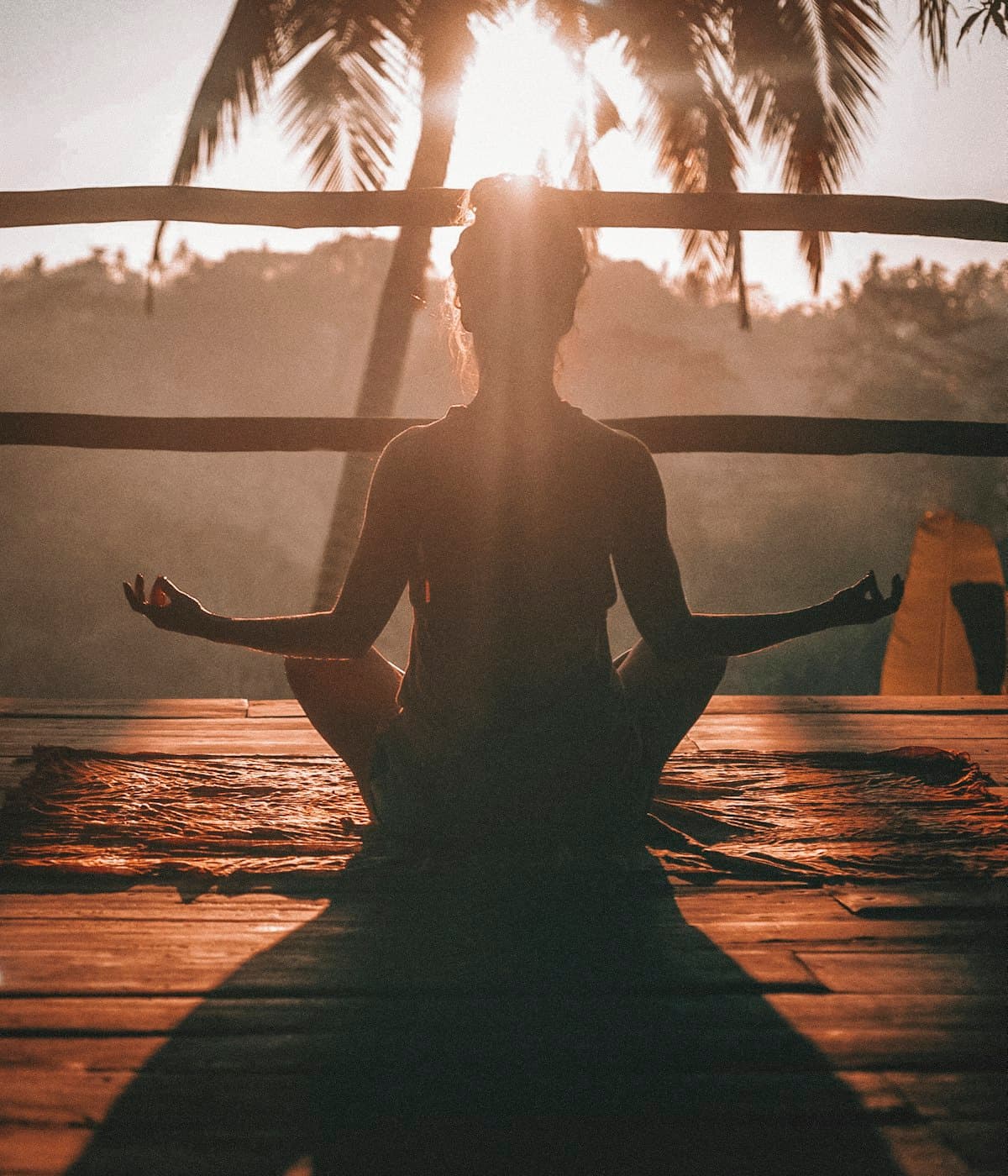 A woman meditating in soft evening light