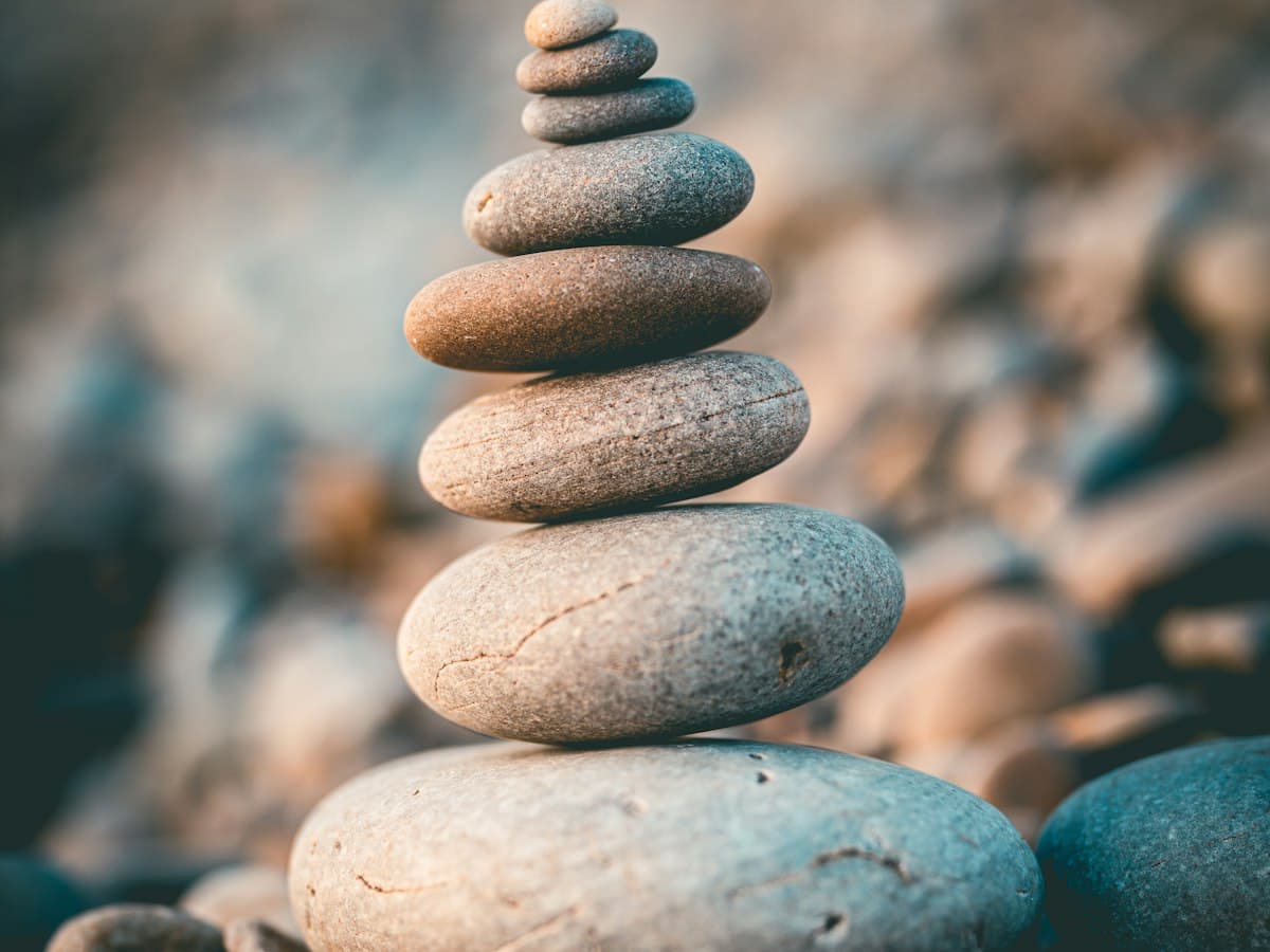 Smooth stones stacked on a quiet beach